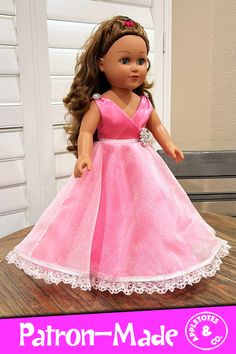 the doll is wearing a pink dress with white lace