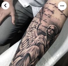 a man with an angel tattoo on his arm