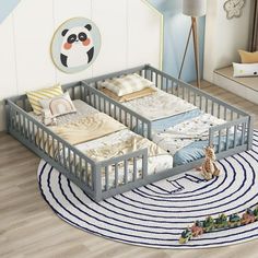 a baby's room with two cribs and a rug on the floor