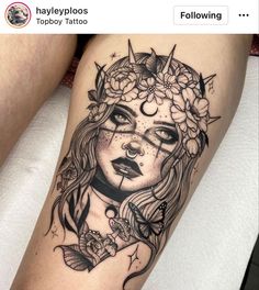 a woman's face with flowers and butterflies on her thigh, in black ink