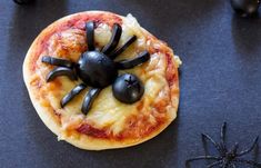 a small pizza with a spider on it