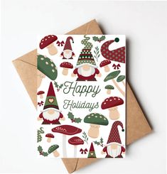 a christmas card with gnomes and holly leaves on it, featuring the words happy holidays