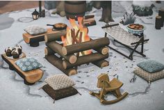 an animated fire pit surrounded by pillows, blankets and rocking horse figurines in the snow