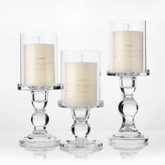 three clear glass candles sitting next to each other