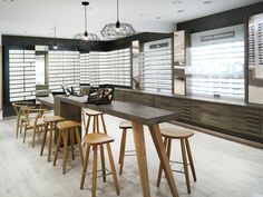 the inside of a store with several wooden stools