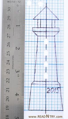 a ruler with a drawing of a lighthouse on it