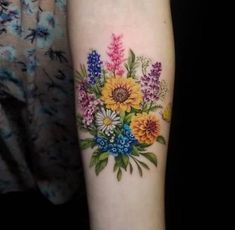 a woman's arm with flowers on it