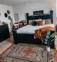 a large bed sitting in the middle of a bedroom next to a dresser and mirror