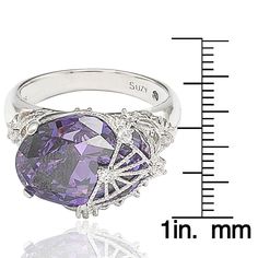 Add a trendy sharp addition to your look with this beautiful ring, featuring an oval-cut amethyst colored cubic zirconia with round-cut white cubic zirconia, hand-set in sterling silver. This ring is designed by Suzy Levian with a message. By creating jewelry that is beautiful inside and out, Suzy Levian's message is revealed through a hidden stone set inside the shank of this ring to empower women to discover their inner strength, power and beauty. This ring has a closed under-gallery for comfo Gemstone Brooch, Cubic Zirconia Bracelet, Cubic Zirconia Necklace, Cubic Zirconia Jewelry, Amethyst Color, Beautiful Inside And Out, Empower Women, Jewelry Rings Diamond, Cubic Zirconia Earrings