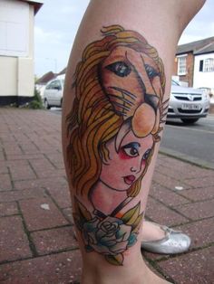 a woman's leg with a lion tattoo on it