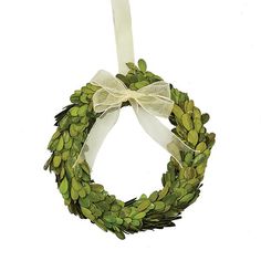 a green wreath hanging on a white wall