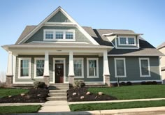 a gray house with white trim and windows