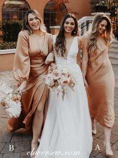 three bridesmaids pose for a photo in front of a building with their bouquets