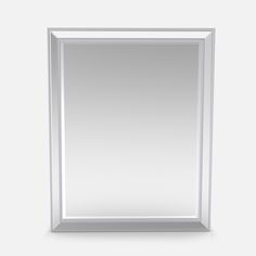 a white framed mirror with beading on the edges and bottom edge, against a gray background