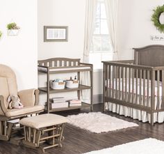 a baby's room with a rocking chair, crib, and changing table