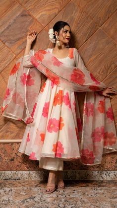 PRODUCT DESCRIPTION: Anarkali : Chanderi Pant: Cotton silk Dupatta: Organza Color: off white with orange and pink printed flowers. work : Gotta lace work, stone work embellishment all over dupatta No. Of Components : Set of 3 Wash Care : Dry Clean Customization : Only Size and Length Of Product SKU#: 11403219WH Disclaimer: All our pieces are handcrafted in our manufacturing unit .We Ensure that our pieces are shot professionally under controlled lighting. Colours tend to be perceived differently Printed Anarkali Suits, Trendy Outfits Indian, Anarkali Dress Pattern, Traditional Indian Dress, Indian Dresses Traditional, Salwar Kamiz, Traditional Indian Outfits, Kurti Designs Party Wear, Designer Dresses Casual