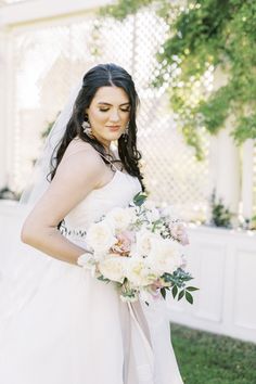 a woman in a wedding dress holding a bouquet