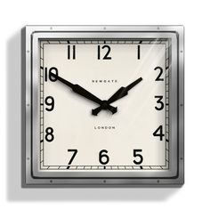 a square clock with black hands and numbers