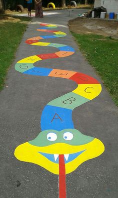 children's artwork painted on the sidewalk in front of a house