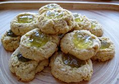 some cookies with jelly on them sitting on a plate