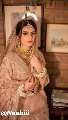 a woman in a bridal outfit posing for the camera