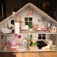 a doll house with furniture and accessories inside