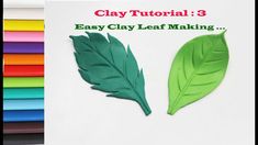 two green leaves sitting next to each other on top of a white paper with the words clay