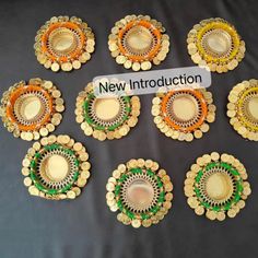 several pieces of gold and green broochies on a black table with a sign that says new instruction