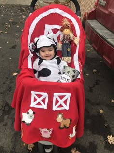 a small child in a costume sitting in a stroller