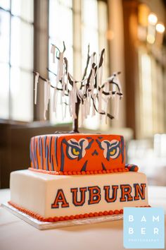 two tiered cake decorated with an auburn logo