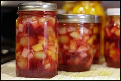 jars filled with fruit sitting on top of a table