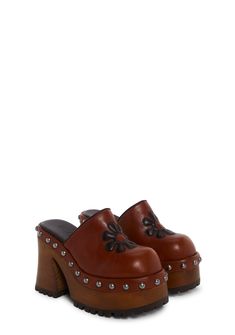 These platform mules have a vegan leather construction, a stitched flower design on top, studded detailing, platform soles, block heels, and a slip-on fit.These platform mules have a vegan leather construction, a stitched flower design on top, studded detailing, platform soles, block heels, and a slip-on fit. Platform Mules Outfit, Mules Outfit, Dolls Kill Outfits, Studded Clogs, Clogs Outfit, Whimsy Goth, Platform Mules, Platform Clogs, Girly Shoes