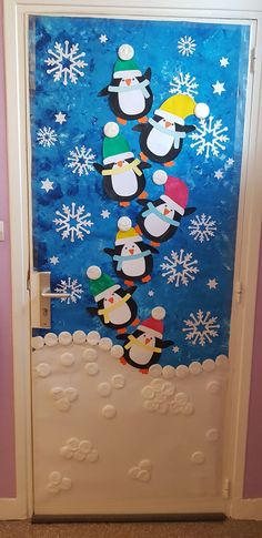 a door decorated with penguins and snowflakes