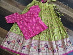 This traditional attire is perfect for young girls aged 6 to 7 years old. Made from soft and semi-benarasi fabric, this pattu pavada/ langa blouse/ lehenga crop top is tailored to perfection. The cute and ethnic design adds a touch of auspiciousness to any occasion. The lehenga length and blouse width can be easily adjusted to fit your child's growing body, ensuring that they can wear it for years to come. Our Satin Benarasi Kids Pattu Pavadai Langa Blouse Suits are ready to ship from Prosper, T Traditional Pista Green Blouse For Navratri, Traditional Pista Green Blouse, Anarkali Blouse With Traditional Patterns In Multicolor, Pista Green Anarkali Set For Puja, Designer Anarkali Sets In Paithani Silk, Designer Paithani Silk Sets, Traditional Paithani Silk Sets For Designer Wear, Designer Fitted Sets In Paithani Silk, Anarkali Paithani Silk Sets For Designer Wear