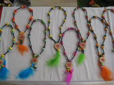 a table topped with lots of colorful beads and tassels on top of it