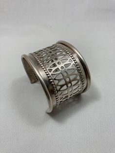 This contemporary recycled silver cuff had a previous life as a vintage casserole dish.  Now it is reborn as a statement  bracelet with a geometric and dot incised pattern design to complement a festive dress or a simple denim shirt.   This airy, smooth bracelet is perfect for a gift or for you.  Each handmade, eco-friendly piece is unique. Minor imperfections from years of use make them a work of art.  Shipped polished in a gift box.  Please visit my shop for other modern creations from family silver:   https://www.etsy.com/shop/KatieWoodMetalStudio Festive Dress, Recycled Silver, Statement Bracelet, Casserole Dish, Previous Life, Silver Cuff Bracelet, Silver Cuff, Denim Shirt, Cuff Bracelet