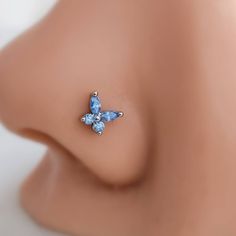 a close up view of an earring with blue stones on the tip of it