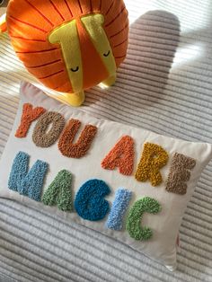 a pillow that says you are magic next to a stuffed animal