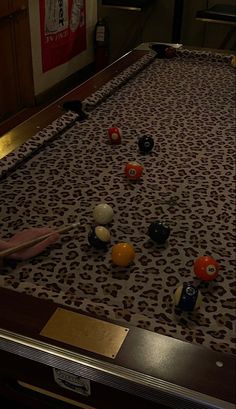 a pool table with balls and cues on it