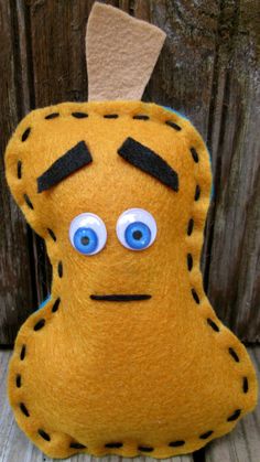 a close up of a stuffed animal on a wooden surface