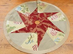 a red and white quilted star on top of a wooden table