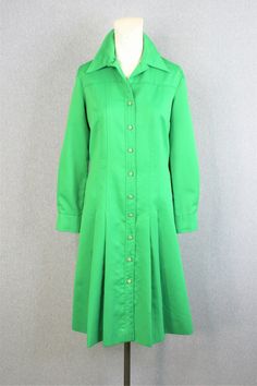 "Smart! This crisp green shirtdress is circa 1970s and can be worn as a sheath, or belted for a shirtwaist look. Pair it with a happy vintage scarf. It is in very good condition without holes or stains. Estimated size 14 40\" bust 36\" waist 44\" hip 42\" nape to hem Purveyor's Note: We have searched far and wide, wrestled bears, braved the cold, traversed mountain ranges, fought pirates, swam with sharks and eaten at many a questionable road side taco stand to provide our customers with one of Fitted Green Shirt Dress For Work, Green Fitted Shirt Dress For Work, Fitted Green Long Sleeve Shirt Dress, Green Fitted Long Sleeve Shirt Dress, Fitted Green Shirt Dress For Daywear, Fitted Green Shirt Dress With Button Closure, Green Formal Shirt Dress For Spring, Formal Green Shirt Dress For Spring, Formal Green Shirt Dress