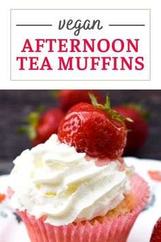 a cupcake with whipped cream and strawberries on top is sitting on a plate