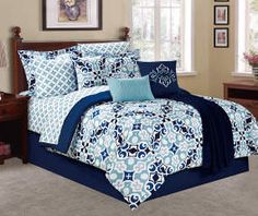 a bed with blue and white comforters in a room