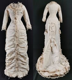 A truly stunning Victorian antique Natural Form / Princess bustle  evening or wedding dress dating to the late 1870s / early 1880s - beautiful as it is, the surviving flower decorations take this to the next level ! One piece, in pale ivory ribbed silk, glossy and structured, with an elegant hourglass figure hugging silhouette. Fitted and boned, fastening in the front with with silk covered buttons from hip height to bust. The low square neck is edged with lace, running all the way down the fron Historical Victorian Ball Gown With Ruffles, Victorian Fitted Gown With Ruffles, Victorian Gown With Ruffles And Fitted Style, Antique Victorian Costume Dress With Historical Design, Antique Victorian Dress Costume With Historical Design, Victorian Ball Gown With Historical Design, Victorian Gown With Ruffles For Costume Events, Fitted Historical Victorian Dress For Wedding, 18th Century Victorian Wedding Dress