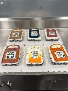 four decorated cakes sitting on top of a counter