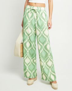 Price Comparison Few Moda $49 STAUD $275 Reformation $198 Product Details The Kiara Pant offers the perfect blend of style and comfort. Featuring an elastic waist and convenient pockets, these pants are made from a breezy linen blend and boast a fun print that adds a touch of playfulness. The relaxed fit ensures all-day comfort and effortless style. - Elastic waist- Drawstring tie- Content: Main Fabric: 20% Linen, 80% Rayon; Lining: 100% Cotton Style# K24WPA00012 Fit Notes - Model wearing a size Hip Style, Chic Pants, Boho Green, Price Comparison, Fun Prints, Linen Pants, Cotton Style, Effortless Style, Linen Blend