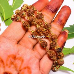 Welcome to KSBJewels collection of sacred Rudraksha beads--a symbol of spirituality, inner peace, and positive energy. Rudraksha beads are seeds from the fruit of the Rudraksha tree, revered for centuries in Hinduism and other spiritual traditions for their powerful healing and meditative properties. Each bead is unique and believed to possess divine energies. Our meticulously crafted Rudraksha Mala features [number of beads] genuine Rudraksha seeds, hand-selected for their quality and authentic Spiritual Mala For Festival Occasions, Adjustable Mala For Festivals And Gifts, Adjustable Mala For Festivals As A Gift, Spiritual Tilla Mala As A Gift, Adjustable Temple Jewelry Mala For Puja, Spiritual Mala For Festivals, Rudraksha Mala, Rudraksha Beads, 108 Bead