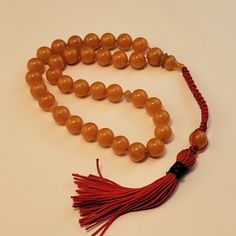 SAME DAY SHIPING Handmade -Rosary -Yellow -Orange Gold Amber color Prayer Beads, Tasbih, Tesbih , Tasbeeh, Misbaha, Subha  Gift for yourself , gift for him,  Specifications Beads Material : Amberoid Amber Composite Tassel Material :  Beads Count :33 Beads Shape :As seen Beads Size :9.5 mm  Total Length : 12 inch Amber Composite (Amberoid) is a composite material made of amber powder mixed into the base of the pheasive resin. Colors are given using various dyes https://www.etsy.com/shops/PashaStone Yellow 8mm Bohemian Beads, Bohemian Yellow 8mm Beads, Adjustable Yellow Spiritual Beads, Traditional Yellow Beads For Gift, Traditional Yellow Beads With 108 Count, Round Orange Beads With Spiritual Style, Spiritual Round Orange Beads, Spiritual Orange Round Beads, Traditional Adjustable Amber Beads