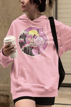 Vaporwave Cat Great Wave Hoodie, Pastel Goth Clothing, Japanese Aesthetic Kawaii Anime Shirt Kanagawa Wave Art Harajuku Cat Cyberpunk Hoodie DETAILS ♥ This vaporwave great wave design is printed on a soft Unisex Heavy Blend Gildan Hooded Sweatshirt ♥ 50% Cotton and 50% Polyester ♥ Medium-heavy fabric (8.0 oz/yd² (271 g/m ♥ Classic fit, runs true to size ♥ Quality print ♥ Knitted in one piece using tubular knit ♥ Adjustable drawstring hood ♥ Spacious kangaroo pouch pocket SIZE Available in 8 size Kawaii Hooded Sweatshirt With Graphic Print, Harajuku Style Pink Hoodie With Graphic Print, Kawaii Long Sleeve Hoodie With Cat Design, Hooded Cat Print Sweatshirt For Streetwear, Hooded Sweatshirt With Cat Print For Streetwear, Pink Harajuku Sweatshirt With Anime Print, Pink Casual Hoodie With Anime Print, Casual Pink Hoodie With Anime Print, Cat Design Hoodie Sweatshirt For Streetwear